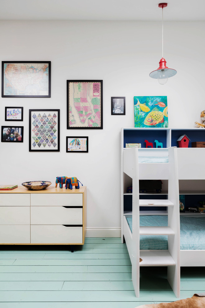 Photo of a large traditional kids' bedroom for kids 4-10 years old and boys in London with white walls, painted wood floors and turquoise floor.