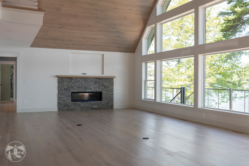 Photo of a large contemporary open plan living room in Other with white walls, light hardwood flooring, a ribbon fireplace, a stacked stone fireplace surround, a built-in media unit, beige floors and a wood ceiling.