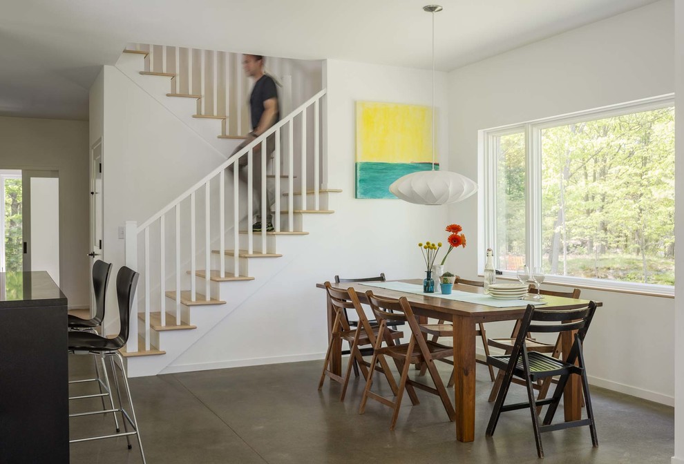 Great room - mid-sized contemporary concrete floor and gray floor great room idea in Burlington with white walls and no fireplace