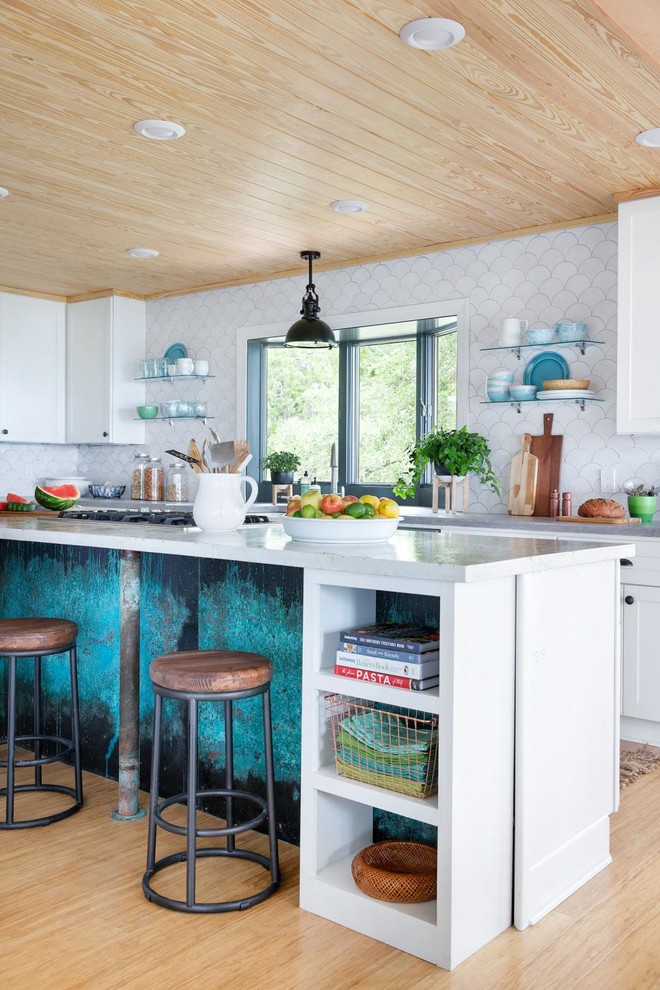 Inspiration for a large beach style l-shaped eat-in kitchen in Orlando with white splashback, ceramic splashback, bamboo floors, open cabinets, with island, concrete benchtops, white cabinets and beige floor.
