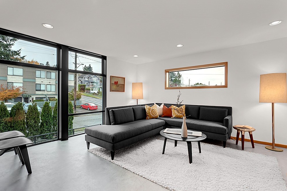 Design ideas for a modern living room in Seattle with concrete floors.