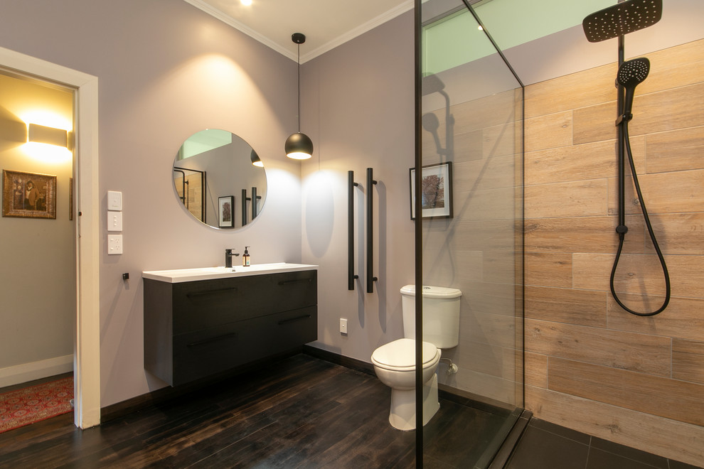 Photo of a mid-sized contemporary master bathroom in Auckland with a double shower, beige tile, purple walls, dark hardwood floors, brown floor, an open shower, a two-piece toilet and a wall-mount sink.
