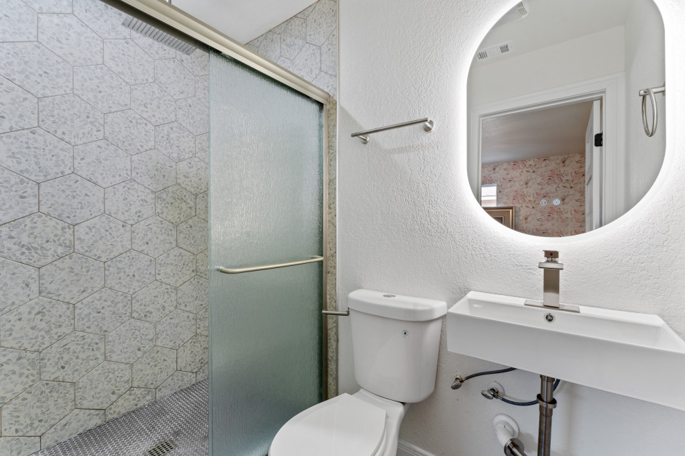 Photo of a small kids bathroom with an open shower, a one-piece toilet, multi-coloured tile, ceramic tile, white walls, mosaic tile floors, a pedestal sink, solid surface benchtops, purple floor, an open shower, white benchtops, a niche and a single vanity.