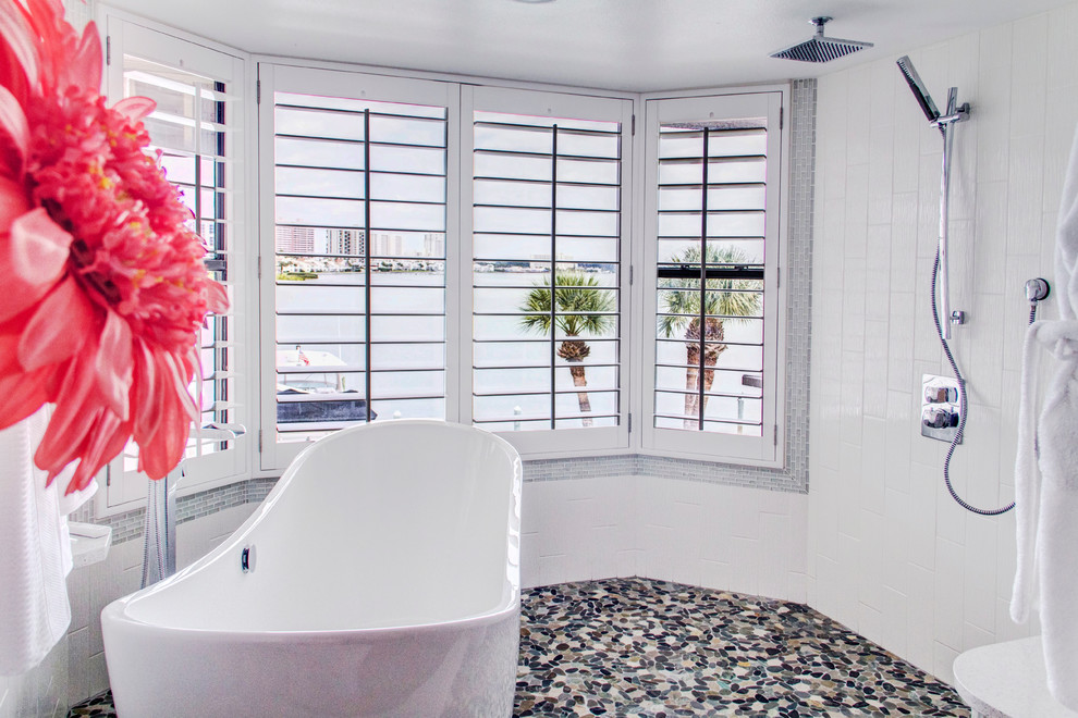 Inspiration for a mid-sized coastal master white tile and porcelain tile pebble tile floor bathroom remodel in Tampa with light wood cabinets, a two-piece toilet, white walls, a pedestal sink and quartz countertops