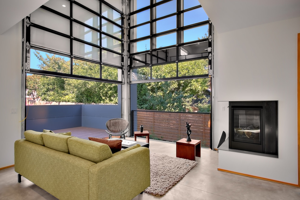 Inspiration for an industrial living room in Seattle with concrete floors and a corner fireplace.