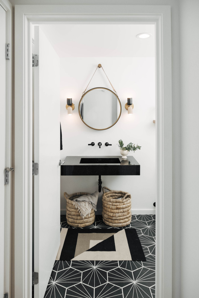 Small contemporary 3/4 bathroom in Other with white walls, cement tiles, a wall-mount sink, granite benchtops, black floor, black benchtops and a single vanity.