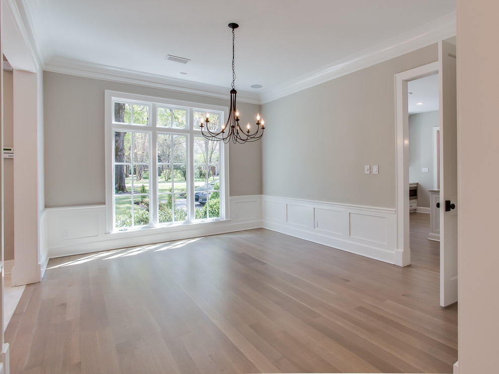 Example of a mid-sized transitional light wood floor dining room design with gray walls