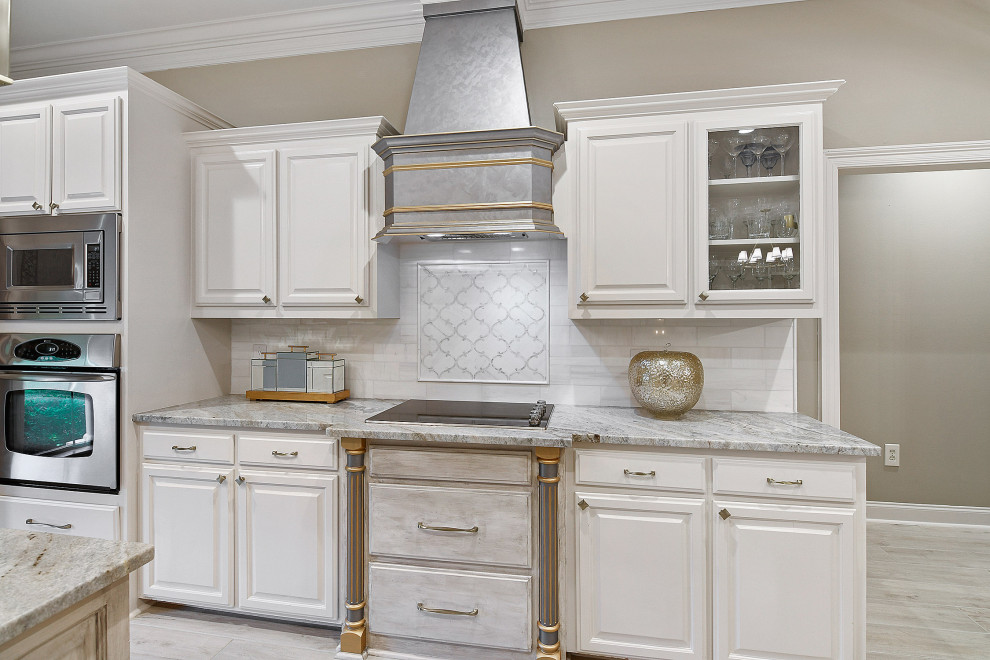 Inspiration for a mid-sized transitional u-shaped porcelain tile and gray floor eat-in kitchen remodel with an undermount sink, raised-panel cabinets, white backsplash, stainless steel appliances, an island, white cabinets, granite countertops, marble backsplash and multicolored countertops