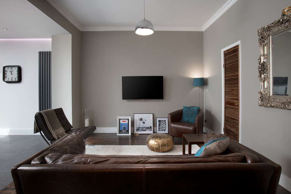 Inspiration for a mid-sized contemporary open concept living room in London with grey walls and brown floor.