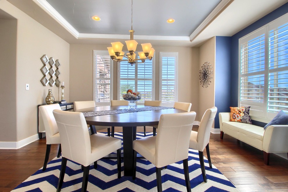 Mid-sized transitional open plan dining in Denver with blue walls, dark hardwood floors, no fireplace and brown floor.