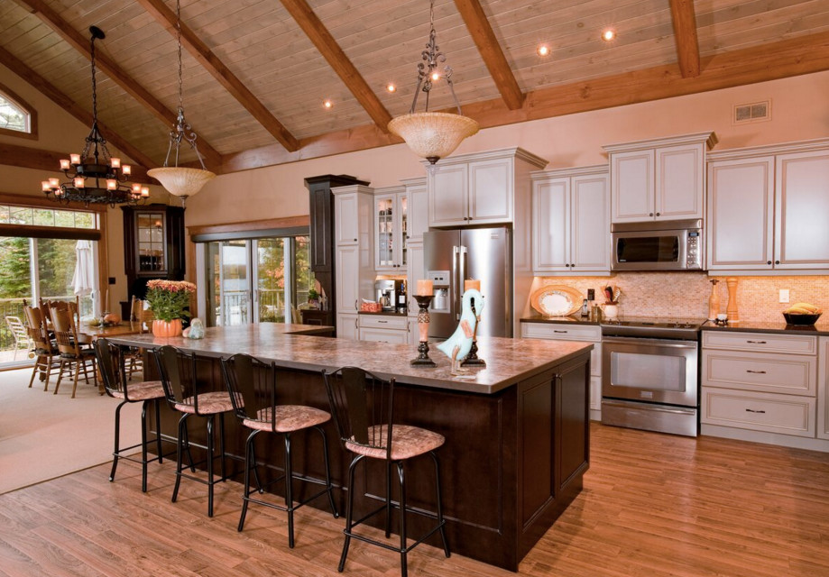 Large mountain style galley light wood floor open concept kitchen photo in Boston with an undermount sink, shaker cabinets, dark wood cabinets, granite countertops, stainless steel appliances and an island