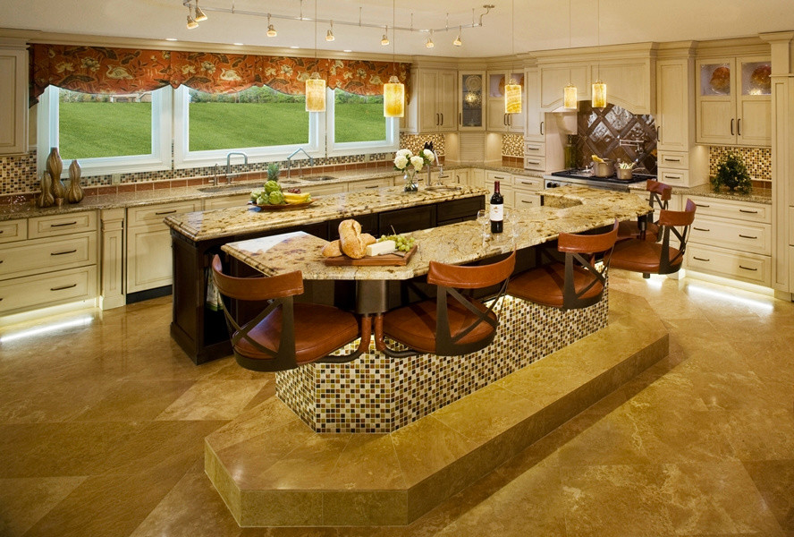 Transitional travertine floor kitchen photo in Jacksonville with light wood cabinets, granite countertops, multicolored backsplash, mosaic tile backsplash, paneled appliances, two islands, an undermount sink and raised-panel cabinets