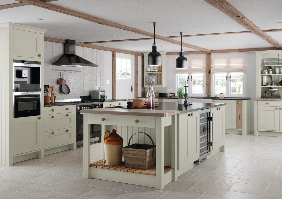 Large country u-shaped separate kitchen in Other with a farmhouse sink, recessed-panel cabinets, beige cabinets, granite benchtops, white splashback, ceramic splashback, stainless steel appliances and with island.