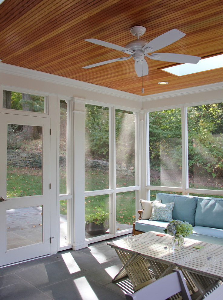 Large transitional sunroom in DC Metro with concrete floors and a skylight.