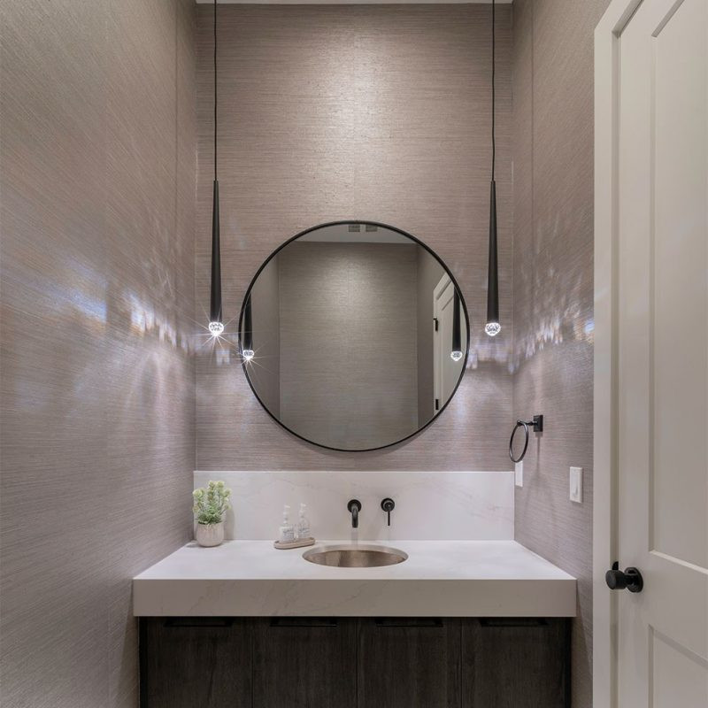 Design ideas for an expansive modern powder room in Vancouver with flat-panel cabinets, brown cabinets, a two-piece toilet, pink walls, porcelain floors, an undermount sink, granite benchtops, white floor, white benchtops, a floating vanity and wallpaper.