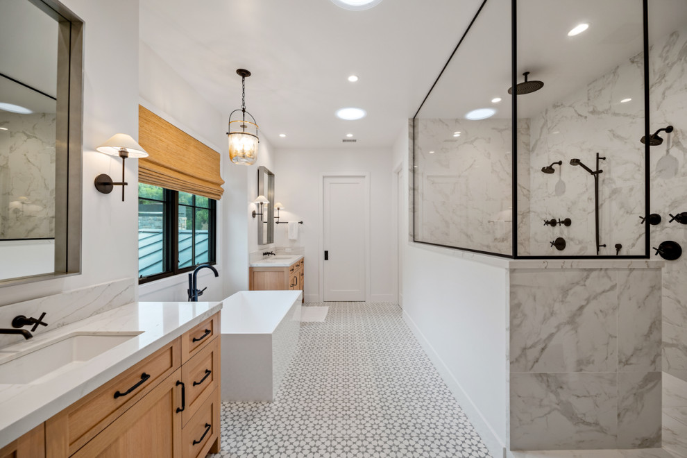 This is an example of an expansive country master bathroom in Los Angeles with shaker cabinets, light wood cabinets, a freestanding tub, a double shower, white tile, porcelain tile, white walls, cement tiles, an undermount sink, engineered quartz benchtops, an open shower, white benchtops, a double vanity and a built-in vanity.