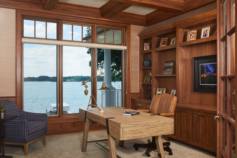 Photo of a beach style home office in Grand Rapids with a library, beige walls, a freestanding desk, beige floor, coffered and wallpaper.