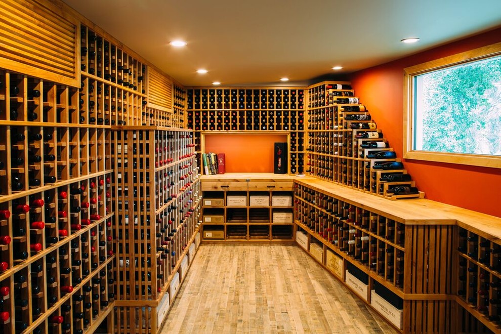 Design ideas for a large traditional wine cellar in Los Angeles with light hardwood floors and storage racks.