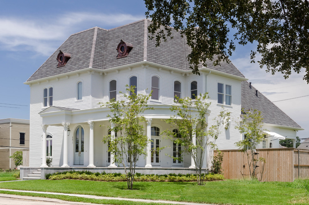 Large traditional two-storey white exterior in New Orleans with wood siding.