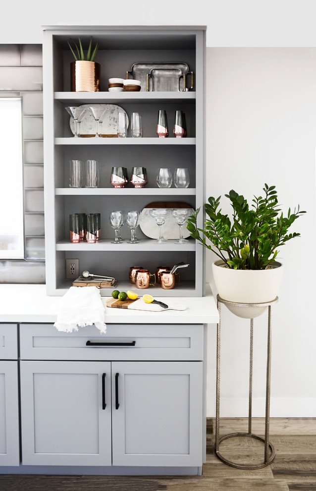Inspiration for a mid-sized transitional u-shaped light wood floor and gray floor eat-in kitchen remodel in Phoenix with an undermount sink, recessed-panel cabinets, gray cabinets, quartz countertops, multicolored backsplash, ceramic backsplash, stainless steel appliances, an island and white countertops