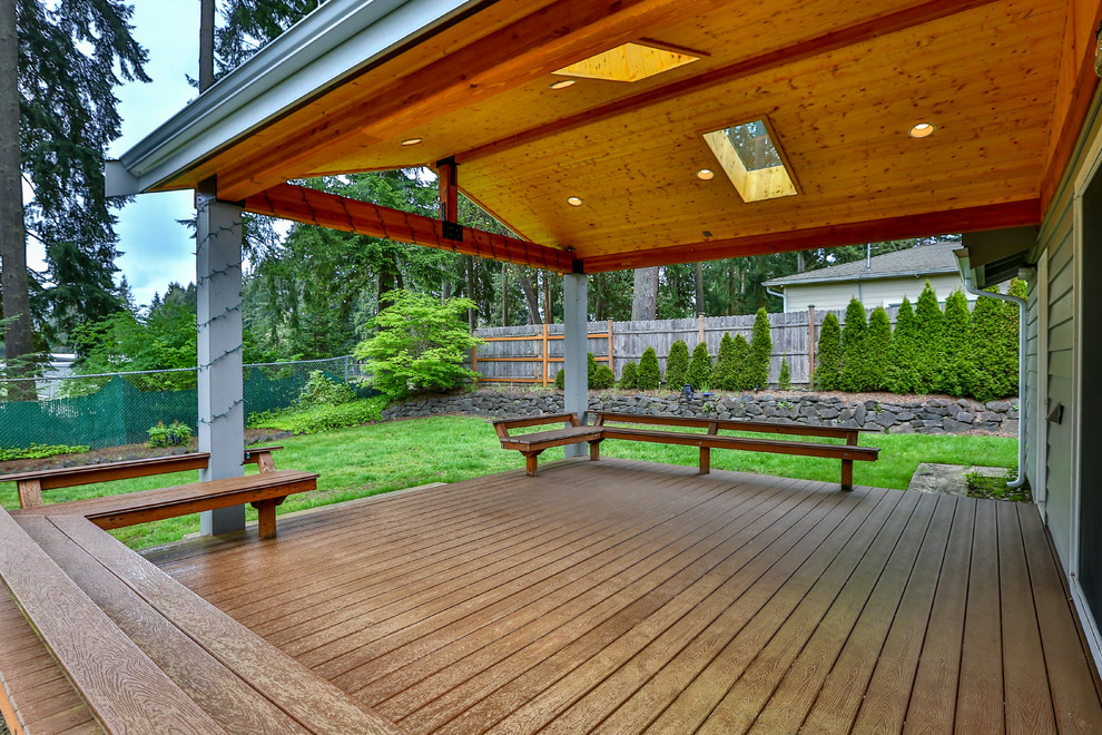 Mid-sized minimalist backyard patio photo in Seattle with decking and a roof extension