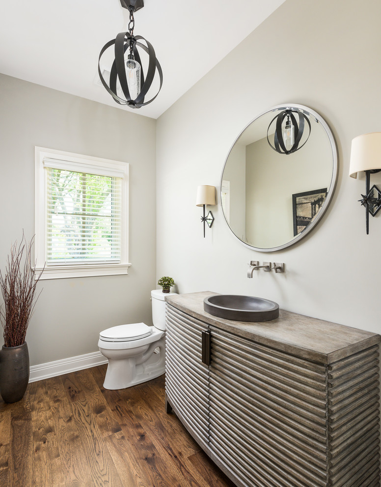 Large traditional powder room in Chicago with dark hardwood floors, a vessel sink, brown floor, furniture-like cabinets, brown cabinets, brown benchtops and beige walls.