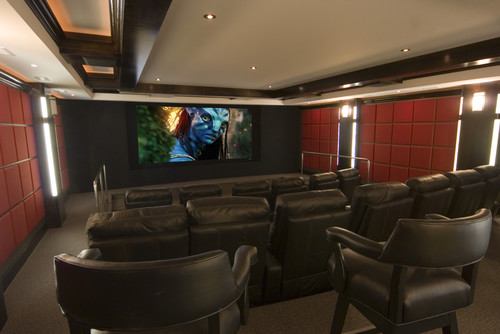 luxury home theatre with dark seating and large screen tv