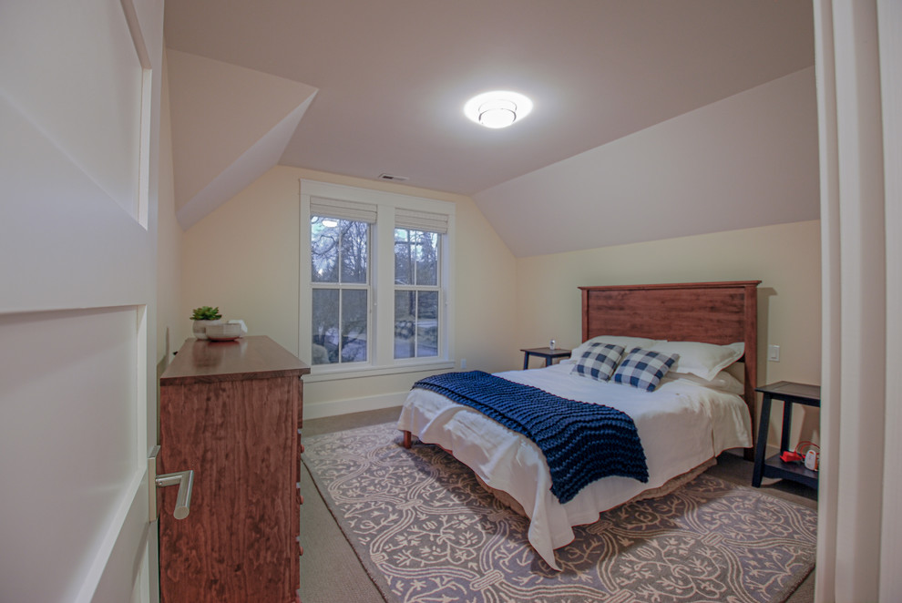 Photo of a large traditional guest bedroom in Portland with yellow walls, carpet and grey floor.