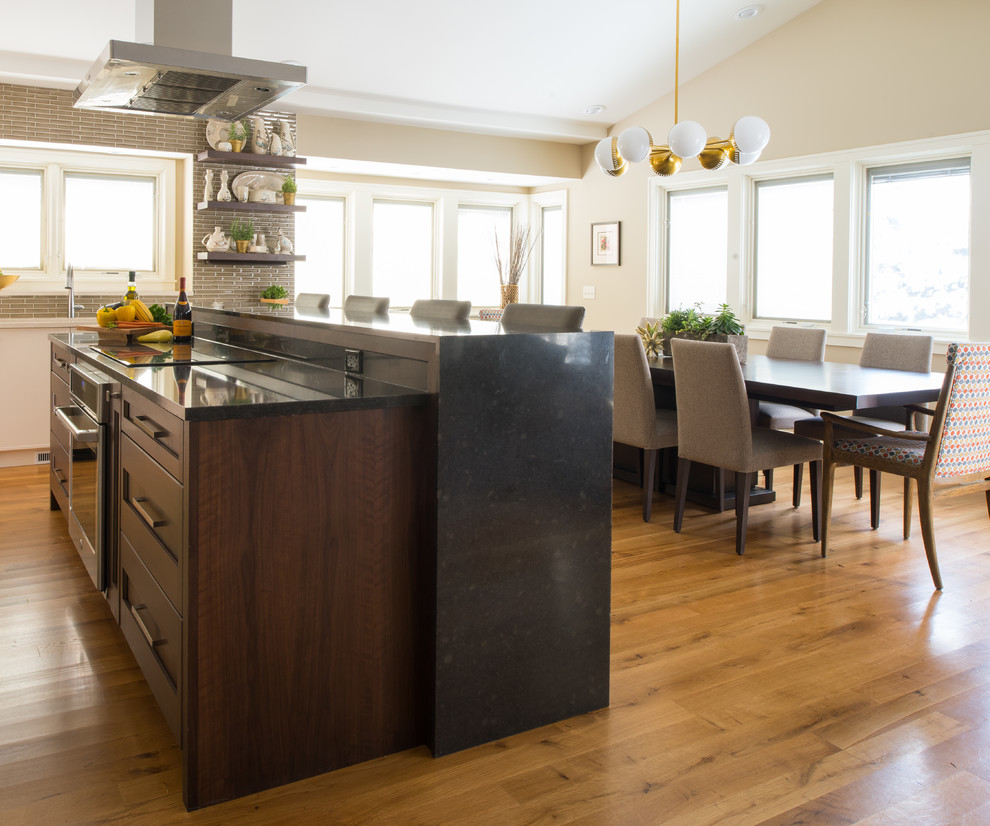 Design ideas for a mid-sized midcentury eat-in kitchen in Minneapolis with beaded inset cabinets, dark wood cabinets, brown splashback, porcelain splashback and with island.