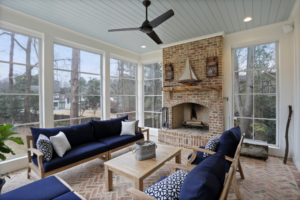 Photo of a transitional sunroom in Atlanta with brick floors, a standard fireplace, a brick fireplace surround, a standard ceiling and multi-coloured floor.