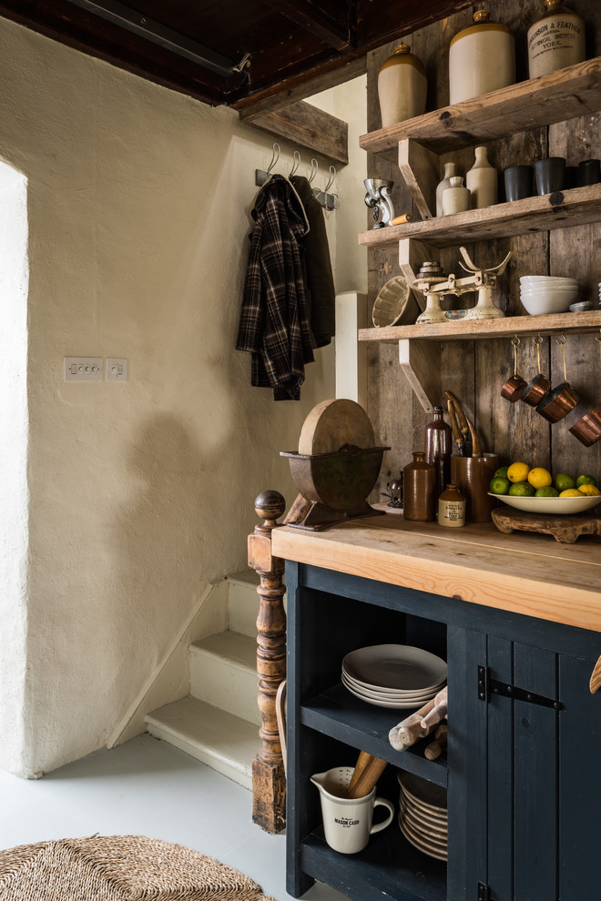 Country kitchen in Cornwall with open cabinets and grey cabinets.