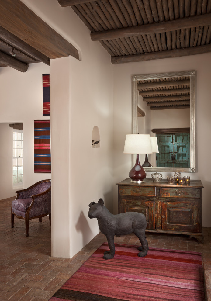 Design ideas for a large foyer in Albuquerque with beige walls and brick floors.