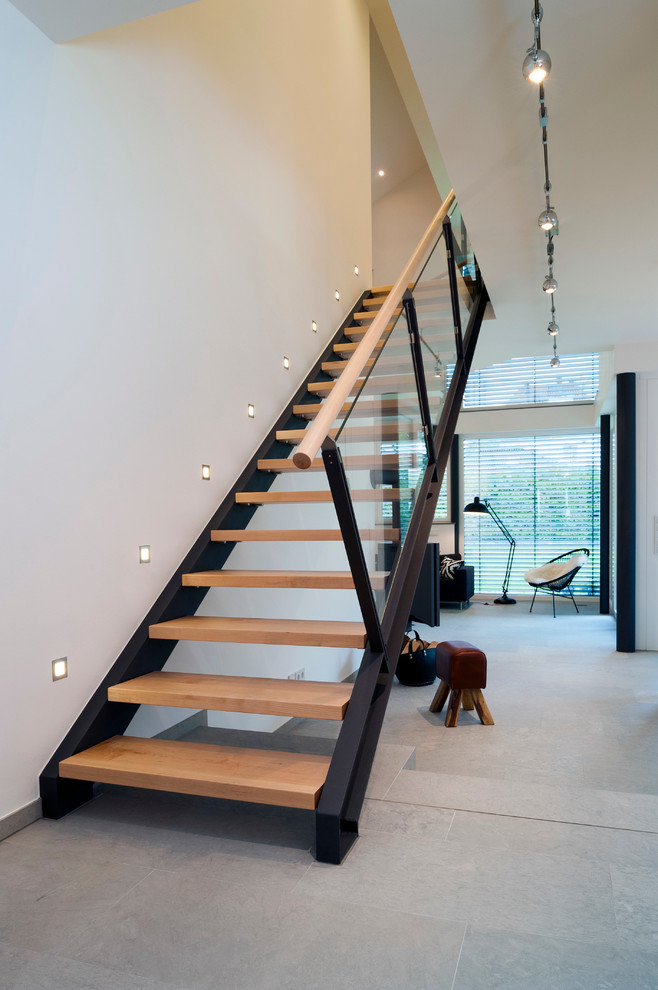 Design ideas for a mid-sized contemporary wood straight staircase in Hanover.