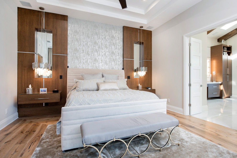 Inspiration for a contemporary master bedroom in Orlando with beige walls, medium hardwood floors and brown floor.
