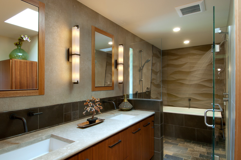 Mid-sized contemporary master bathroom in Seattle with flat-panel cabinets, medium wood cabinets, a freestanding tub, a shower/bathtub combo, a one-piece toilet, multi-coloured tile, porcelain tile, slate floors, an undermount sink and limestone benchtops.