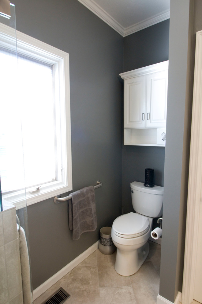 Example of a mid-sized transitional master gray tile and ceramic tile ceramic tile walk-in shower design with an undermount sink, raised-panel cabinets, white cabinets, granite countertops, a two-piece toilet and gray walls