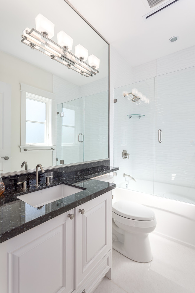 Mid-sized contemporary 3/4 bathroom in Vancouver with white cabinets, a shower/bathtub combo, white walls, an undermount sink, raised-panel cabinets, an alcove tub, a two-piece toilet, white tile, porcelain floors and granite benchtops.