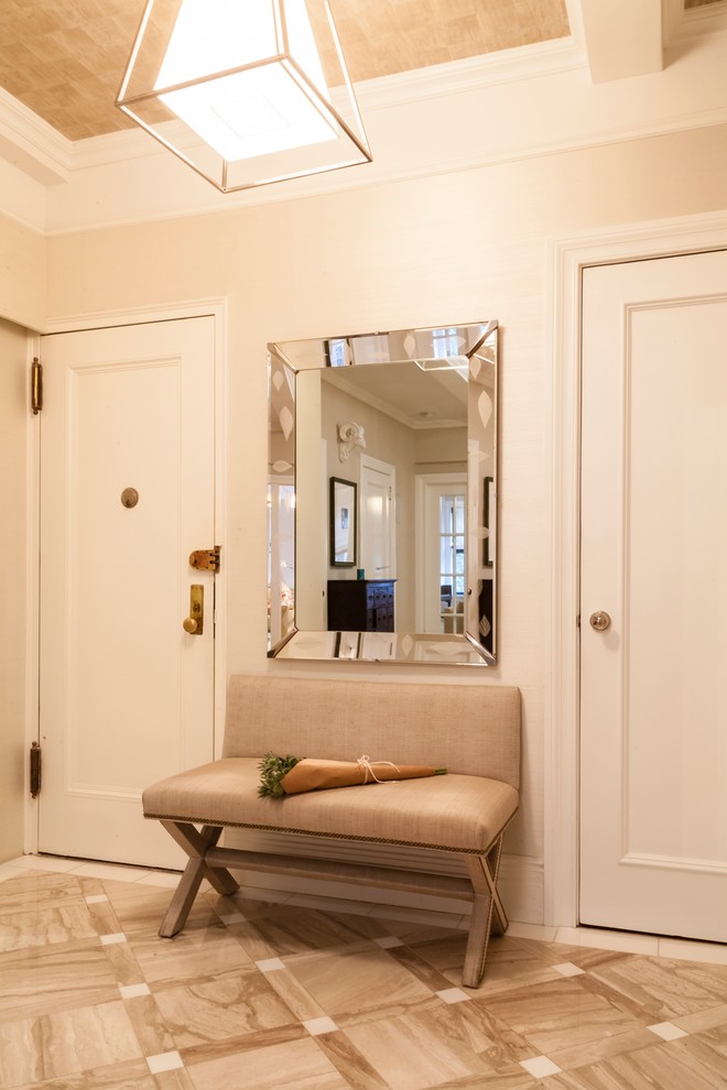 Photo of a mid-sized transitional foyer in New York with white walls, marble floors, a single front door and a white front door.