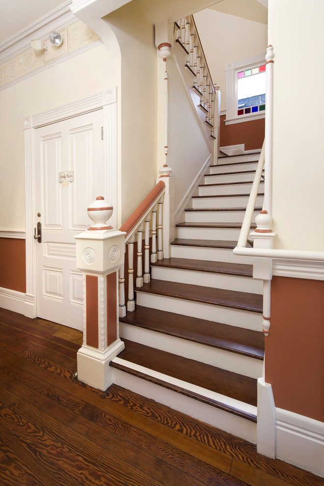 Photo of a traditional wood u-shaped staircase in Santa Barbara with painted wood risers.