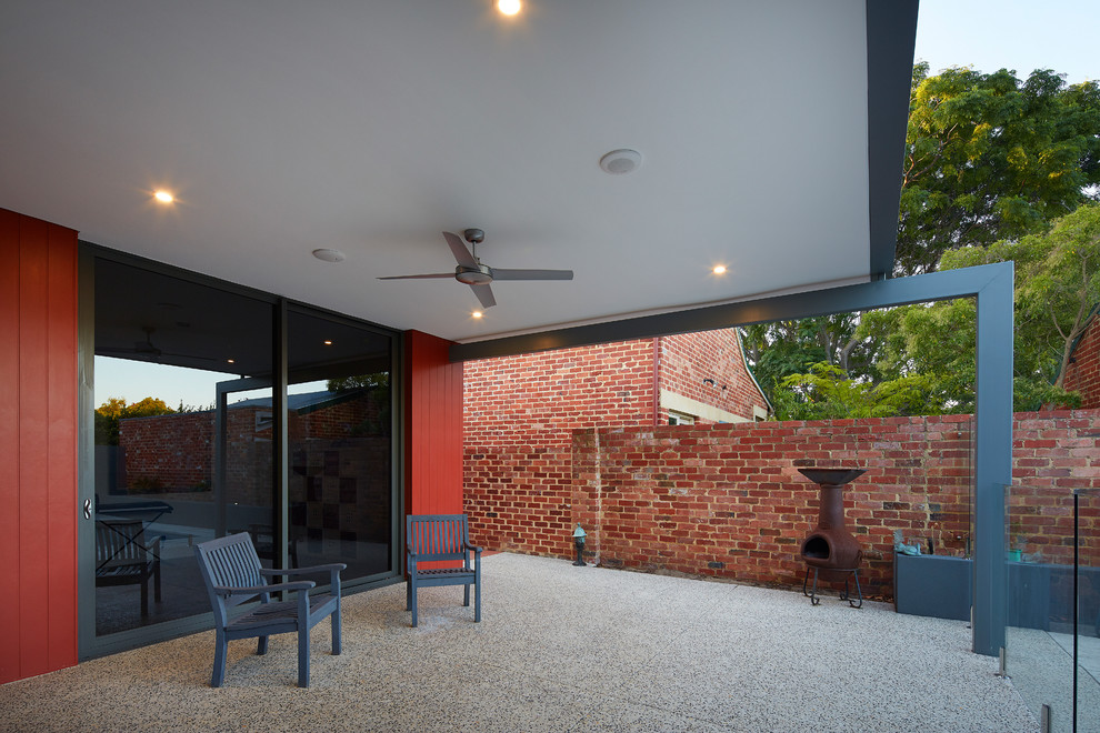 This is an example of a mid-sized contemporary one-storey red exterior in Perth with concrete fiberboard siding and a flat roof.
