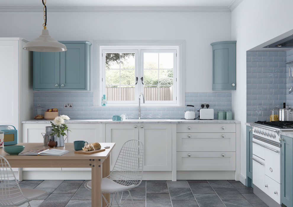 Inspiration for a mid-sized country l-shaped eat-in kitchen in Manchester with shaker cabinets, white cabinets, blue splashback, subway tile splashback, no island, a drop-in sink, marble benchtops, ceramic floors and white appliances.