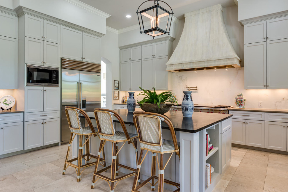 Inspiration for a transitional u-shaped kitchen in Austin with shaker cabinets, white cabinets, white splashback, stone slab splashback, stainless steel appliances and with island.