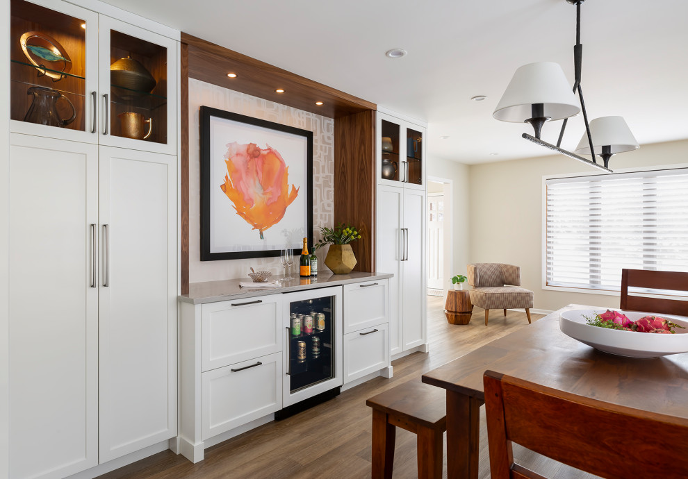 Cette photo montre une salle à manger ouverte sur la cuisine chic de taille moyenne avec un sol en vinyl et un sol marron.