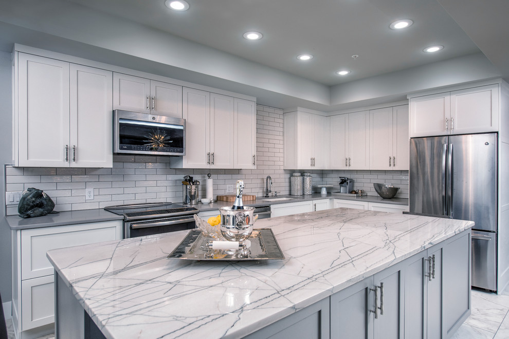 Mid-sized transitional l-shaped eat-in kitchen photo with flat-panel cabinets, white cabinets and an island