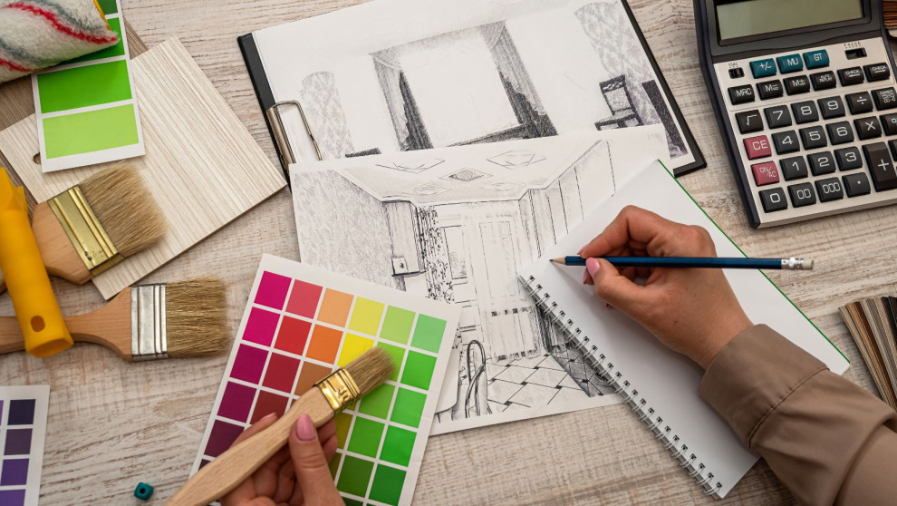 interior designer with pencil and paintbrushes