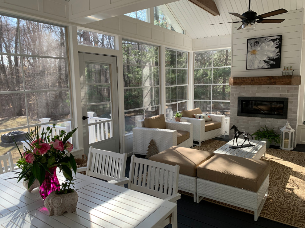 This is an example of a mid-sized country sunroom in Other with vinyl floors, a standard fireplace and blue floor.