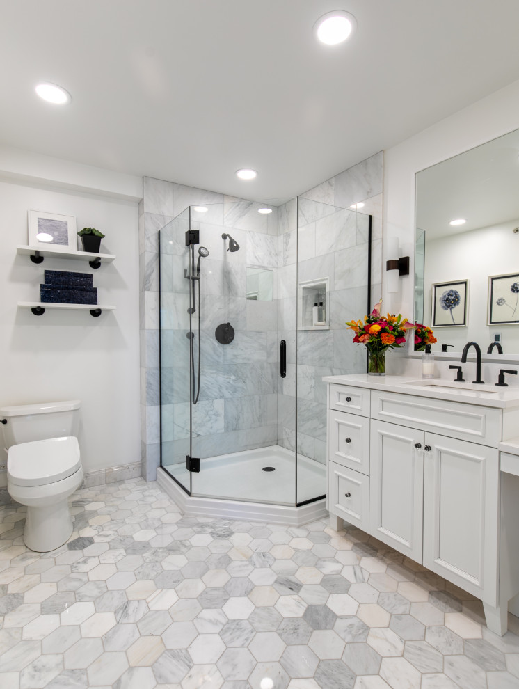 This is an example of a medium sized traditional ensuite bathroom in Chicago with shaker cabinets, white cabinets, a corner shower, a bidet, white tiles, marble tiles, white walls, marble flooring, a submerged sink, engineered stone worktops, grey floors, a hinged door, white worktops, double sinks and a built in vanity unit.