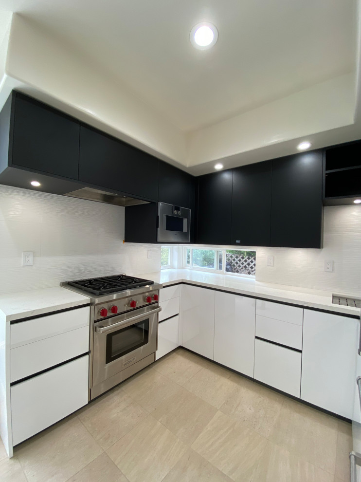 Small contemporary u-shaped eat-in kitchen with flat-panel cabinets, quartz benchtops and mosaic tile splashback.