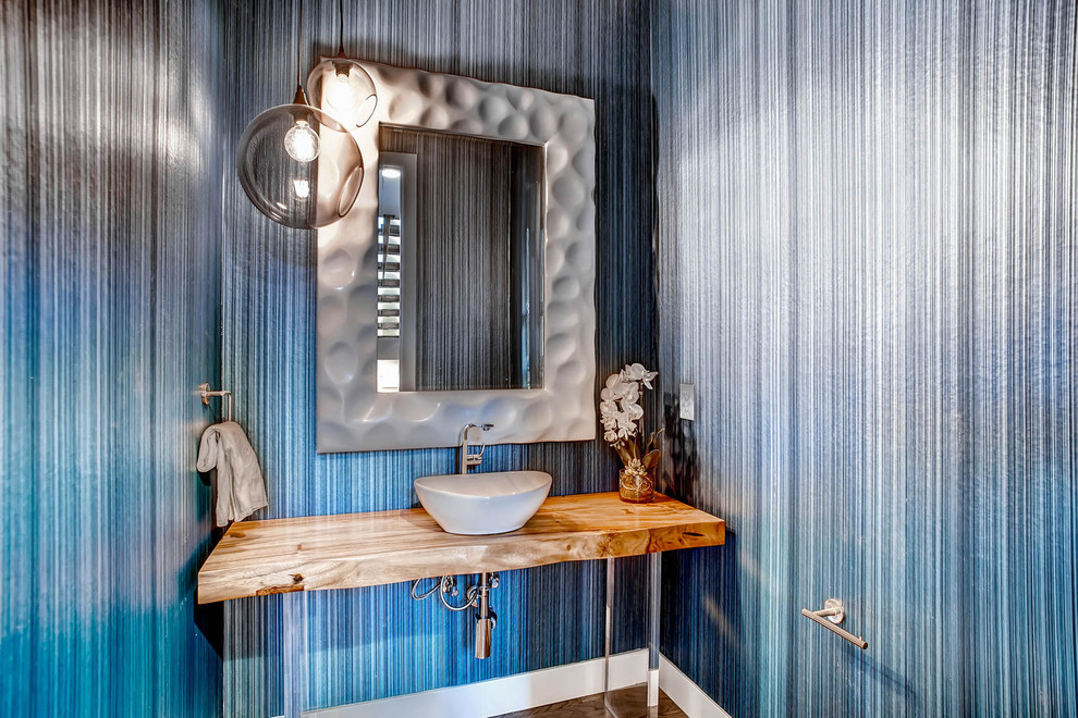 Inspiration for a mid-sized contemporary powder room in Other with blue walls, wood benchtops and brown benchtops.