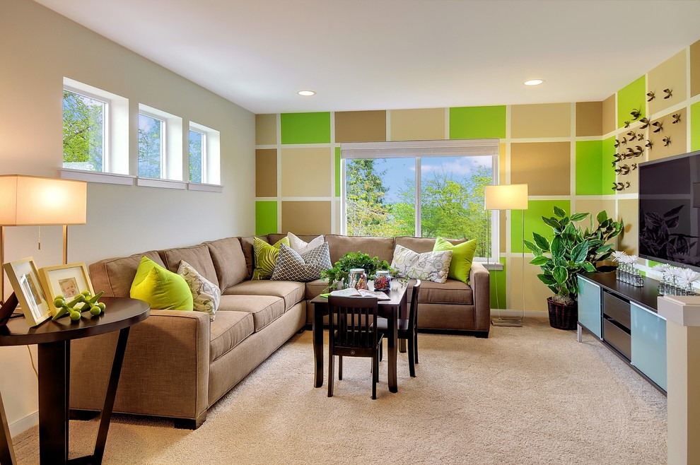 Contemporary family room in Seattle with green walls, carpet and a wall-mounted tv.
